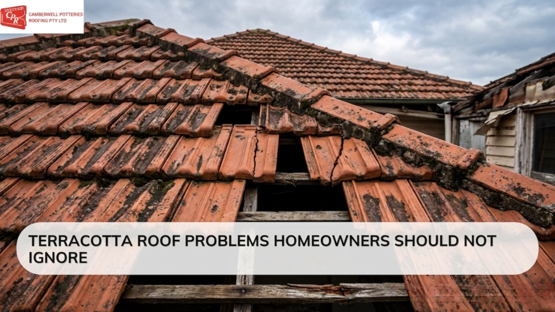 Terracotta roof with cracked and broken tiles, moss buildup, and visible roof damage on an older Melbourne home under cloudy skies.